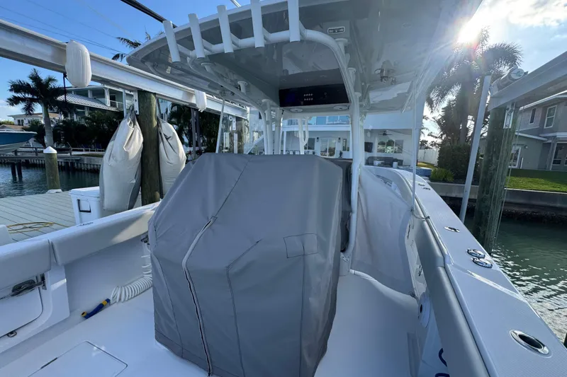 High Steaks Yacht Photos Pics 2024 Jupiter 38 HFS boat interior with covered console, docked in a sunny marina.