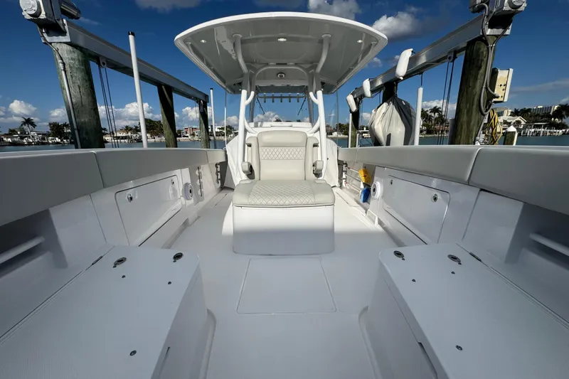 High Steaks Yacht Photos Pics 2024 Jupiter 38 HFS boat interior with seating and storage, docked under a clear sky.