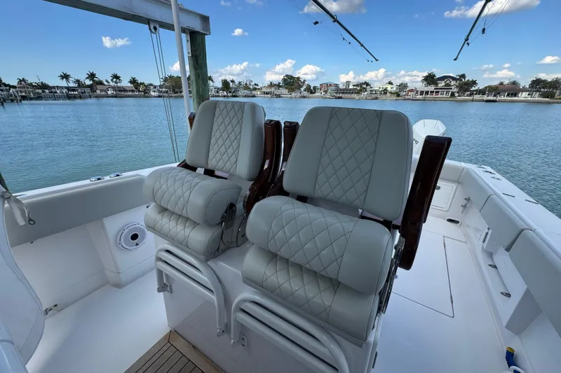 High Steaks Yacht Photos Pics 2024 Jupiter 38 HFS boat interior with luxurious seating and scenic waterfront view.