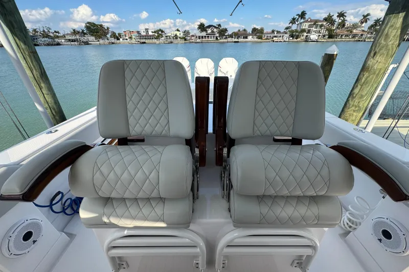 High Steaks Yacht Photos Pics Luxurious seating on 2024 Jupiter 38 HFS boat, overlooking serene waterfront.