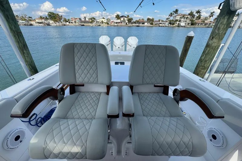 High Steaks Yacht Photos Pics Luxurious seating on 2024 Jupiter 38 HFS boat with waterfront view.