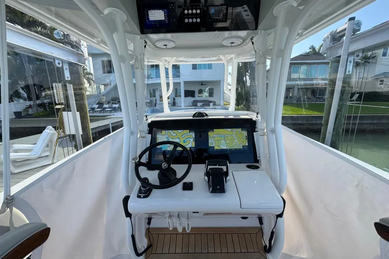 High Steaks Yacht Photos Pics 2024 Jupiter 38 HFS boat helm with navigation screens and steering wheel.