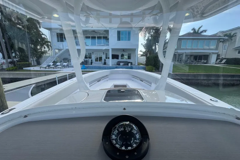 High Steaks Yacht Photos Pics 2024 Jupiter 38 HFS boat docked near luxury waterfront home, view from helm.