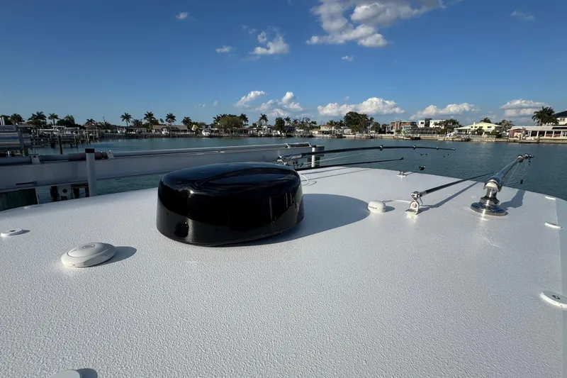 High Steaks Yacht Photos Pics 2024 Jupiter 38 HFS boat deck with clear sky and waterfront view.