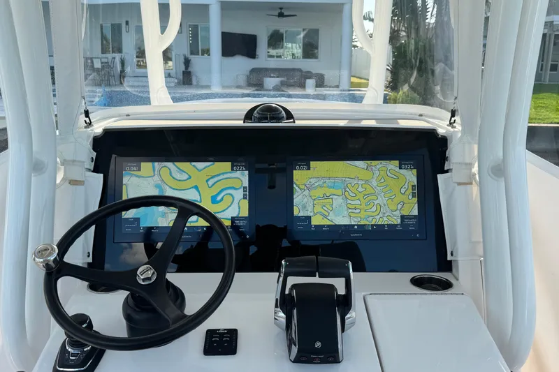 High Steaks Yacht Photos Pics 2024 Jupiter 38 HFS boat dashboard with dual navigation screens and steering wheel.