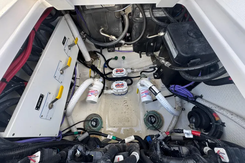 High Steaks Yacht Photos Pics Engine compartment of 2024 Jupiter 38 HFS boat, showcasing wiring and mechanical components.