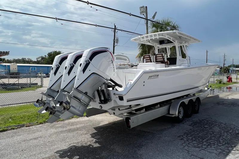 High Steaks Yacht Photos Pics 2024 Jupiter 38 HFS boat with triple outboard engines on a trailer.