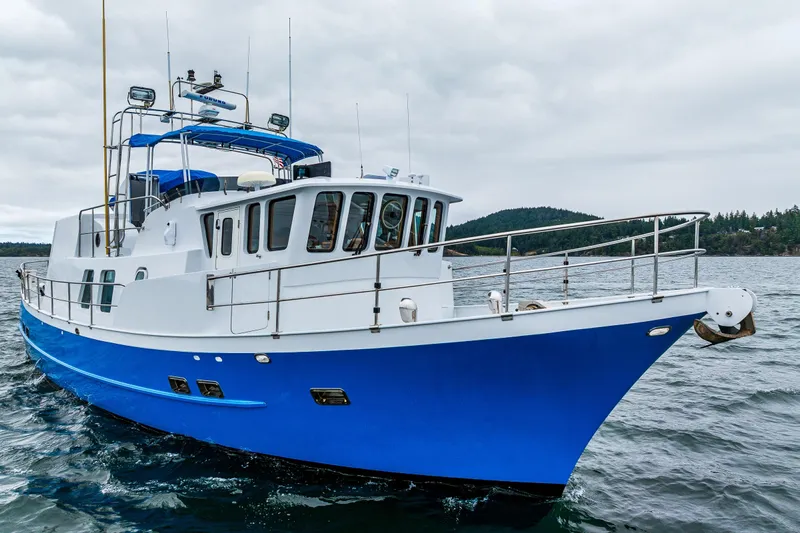 Single Star Yacht Photos Pics 1978 Hidden Harbor Custom Trawler cruising on open water under cloudy skies.