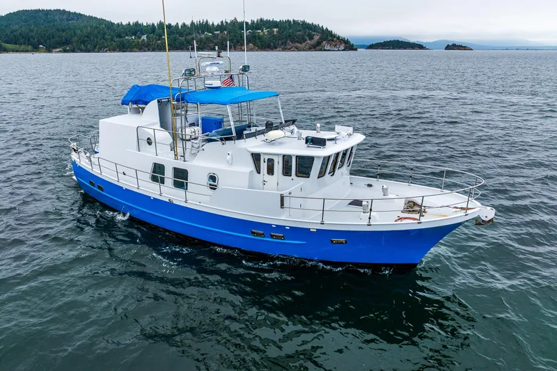 Single Star Yacht Photos Pics 1978 Hidden Harbor Custom Trawler cruising on calm waters with scenic island backdrop.
