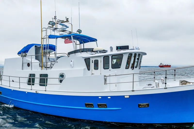 Single Star Yacht Photos Pics 1978 Hidden Harbor Custom Trawler with blue hull cruising on open water.
