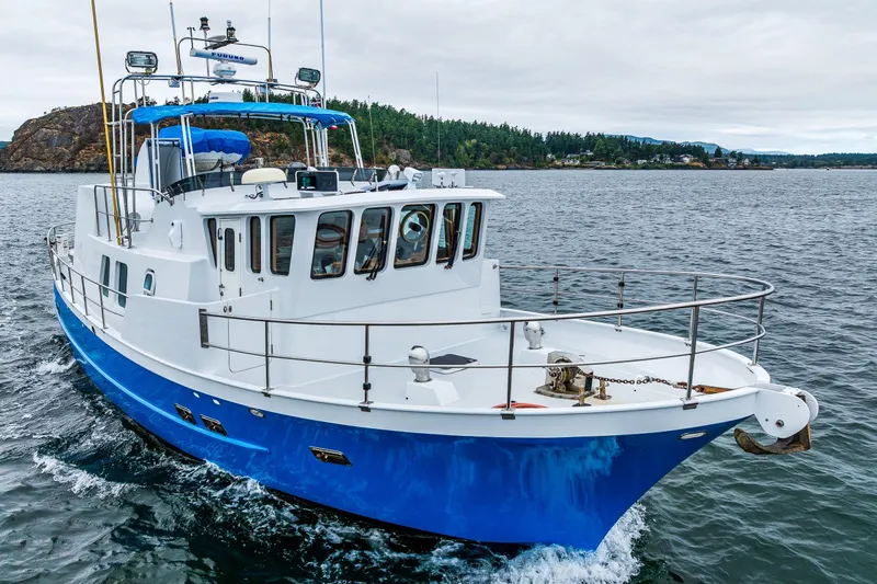 Single Star Yacht Photos Pics 1978 Hidden Harbor Custom Trawler cruising on open water, featuring a blue and white design.