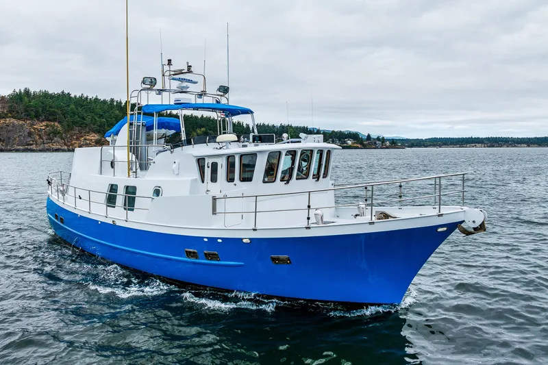 Single Star Yacht Photos Pics 1978 Hidden Harbor Custom Trawler cruising on a scenic waterway with lush green shoreline.