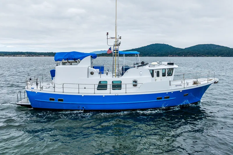 Single Star Yacht Photos Pics 1978 Hidden Harbor Custom Trawler cruising on open water with scenic mountain backdrop.