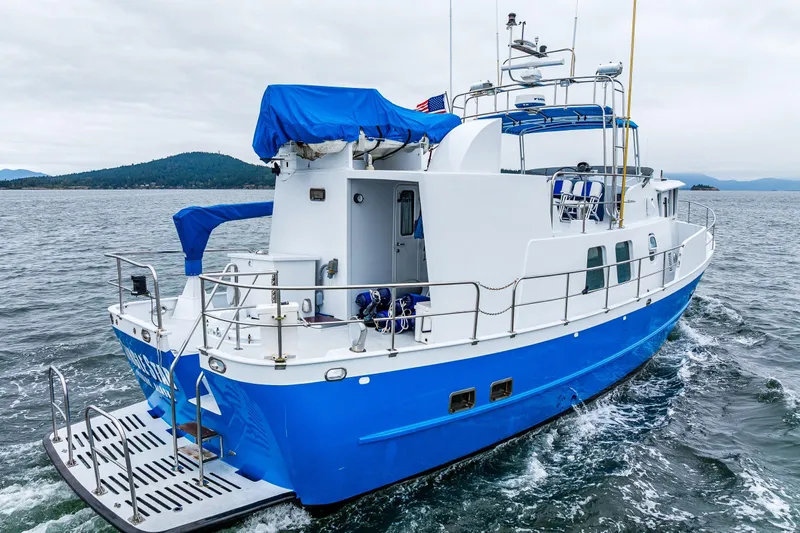 Single Star Yacht Photos Pics 1978 Hidden Harbor Custom Trawler cruising on open water, featuring blue and white design.