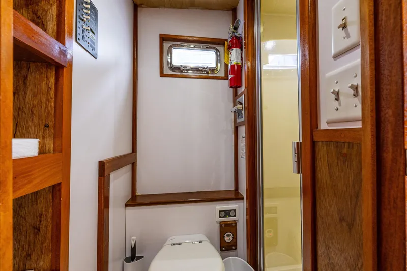 Single Star Yacht Photos Pics Bathroom interior of 1978 Hidden Harbor Custom Trawler with wooden accents and compact design.