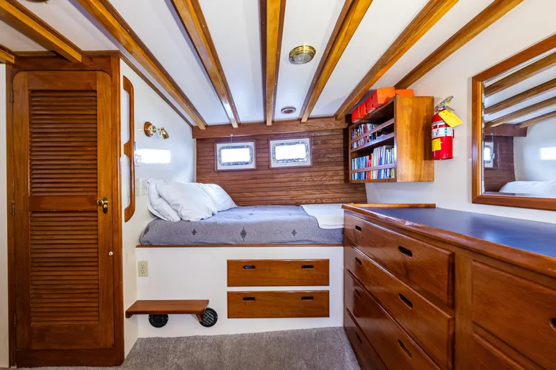 Single Star Yacht Photos Pics Cozy 1978 Hidden Harbor Custom Trawler cabin with wooden interior, bed, and storage.