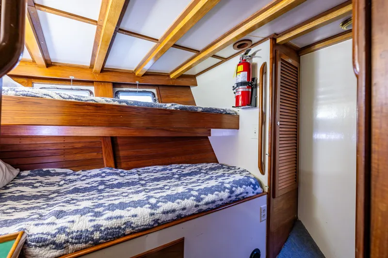 Single Star Yacht Photos Pics Cozy 1978 Hidden Harbor Custom Trawler cabin with wooden bunk beds and nautical decor.