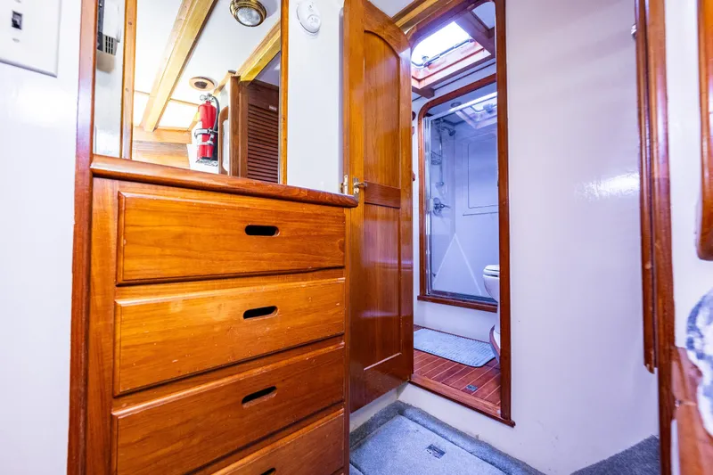 Single Star Yacht Photos Pics Interior of 1978 Hidden Harbor Custom Trawler with wooden cabinetry and bathroom view.