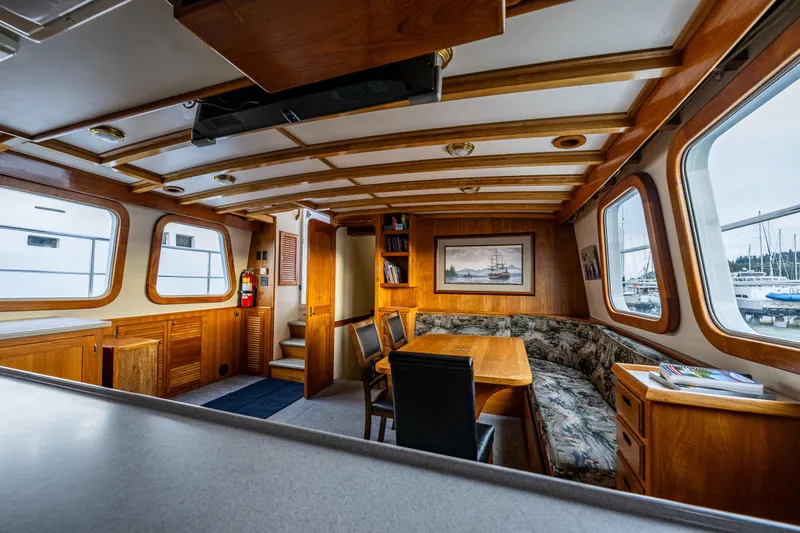 Single Star Yacht Photos Pics Interior of 1978 Hidden Harbor Custom Trawler with wooden furnishings and large windows.