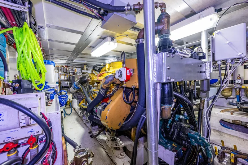 Single Star Yacht Photos Pics Engine room of 1978 Hidden Harbor Custom Trawler with complex machinery and bright lighting.