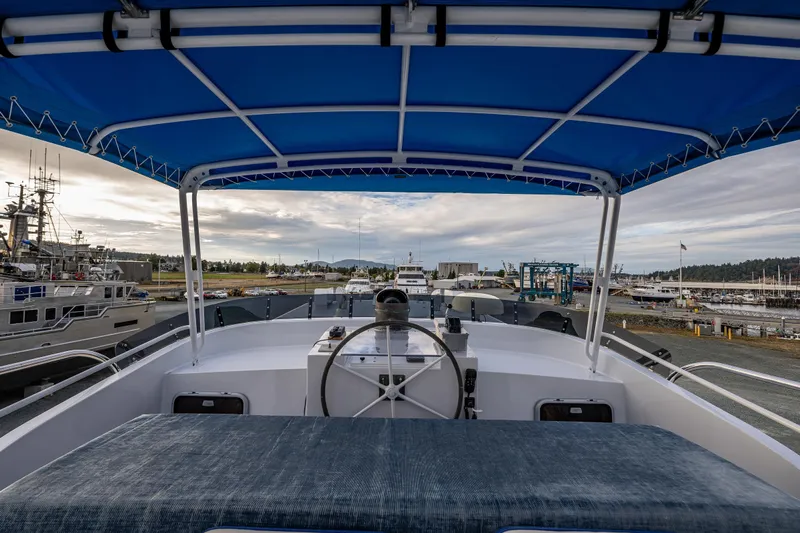 Single Star Yacht Photos Pics 1978 Hidden Harbor Custom Trawler with blue canopy, docked at a marina.