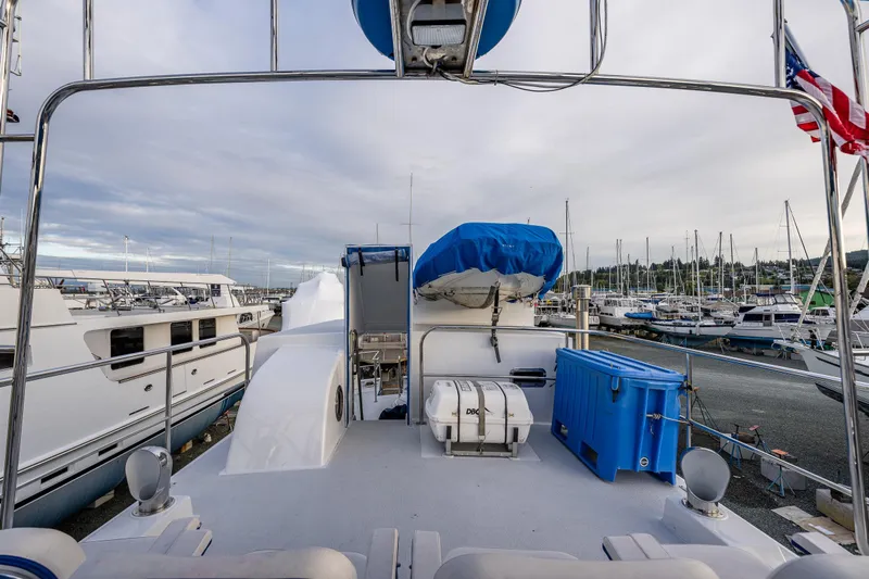 Single Star Yacht Photos Pics 1978 Hidden Harbor Custom Trawler docked at marina, featuring deck equipment and American flag.