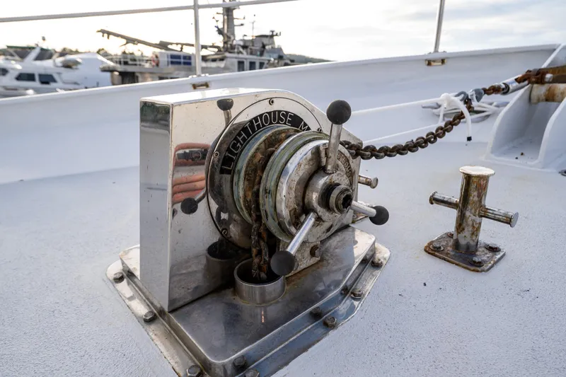Single Star Yacht Photos Pics Vintage 1978 Hidden Harbor Custom Trawler winch on deck, with nautical equipment in background.