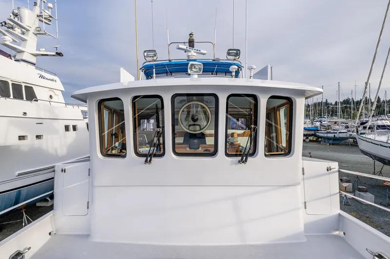 Single Star Yacht Photos Pics 1978 Hidden Harbor Custom Trawler docked, showcasing its classic design and spacious deck.