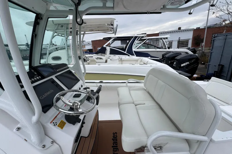  Yacht Photos Pics 2019 Everglades 273 Center Console boat interior with Garmin navigation and white seating.