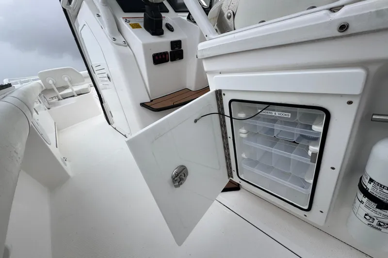  Yacht Photos Pics 2019 Everglades 273 Center Console boat with open storage compartment and fishing gear organizer.