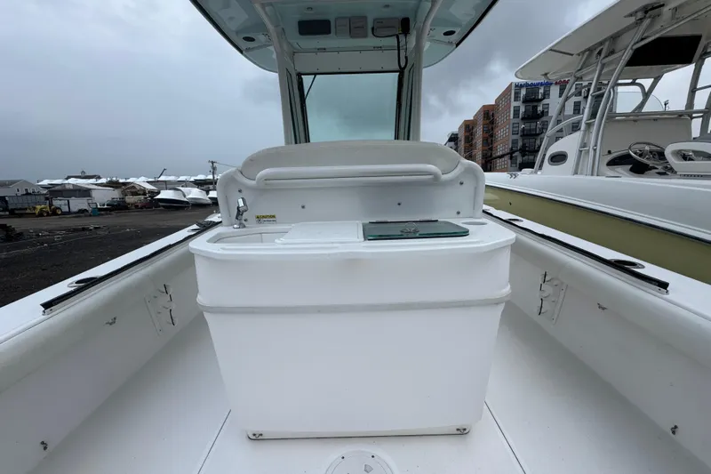  Yacht Photos Pics 2019 Everglades 273 Center Console boat interior with storage compartment, docked at marina.