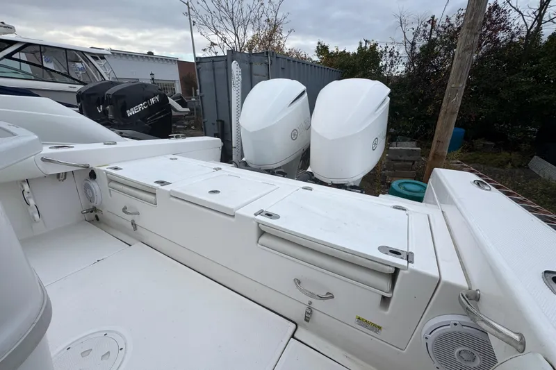  Yacht Photos Pics 2019 Everglades 273 Center Console boat with dual outboard engines, docked outdoors.