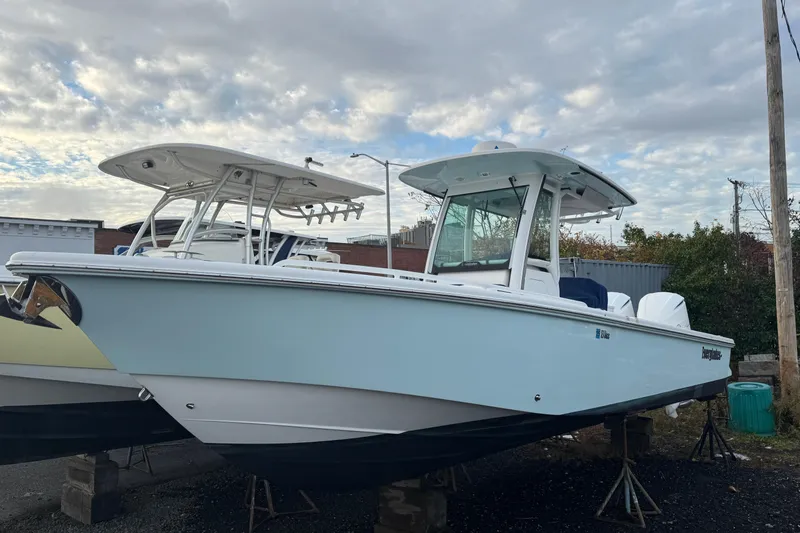  Yacht Photos Pics 2019 Everglades 273 Center Console boat on stands under cloudy sky.