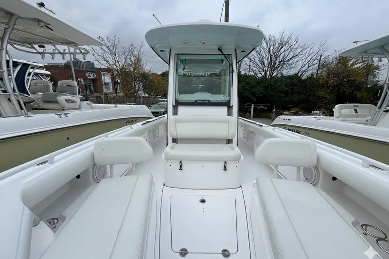  Yacht Photos Pics 2019 Everglades 273 Center Console boat with white seating and console, docked outdoors.