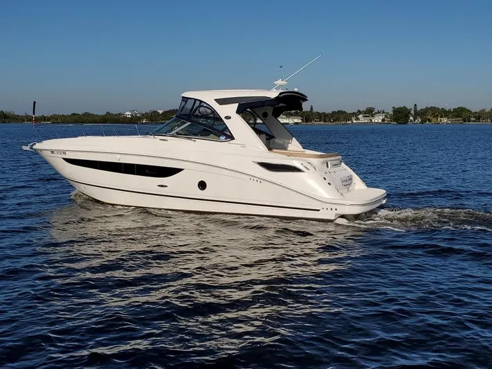  Yacht Photos Pics 2016 Sea Ray 350 Sundancer cruising on a calm lake.