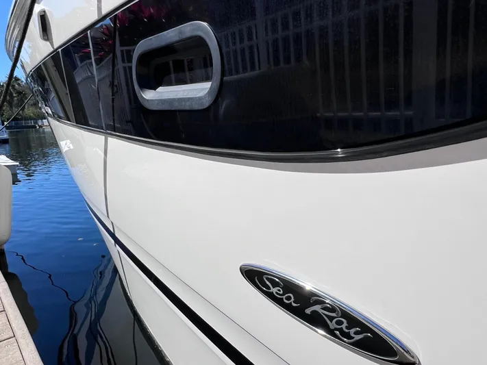  Yacht Photos Pics 2016 Sea Ray 350 Sundancer yacht docked, close-up view of the hull and logo.