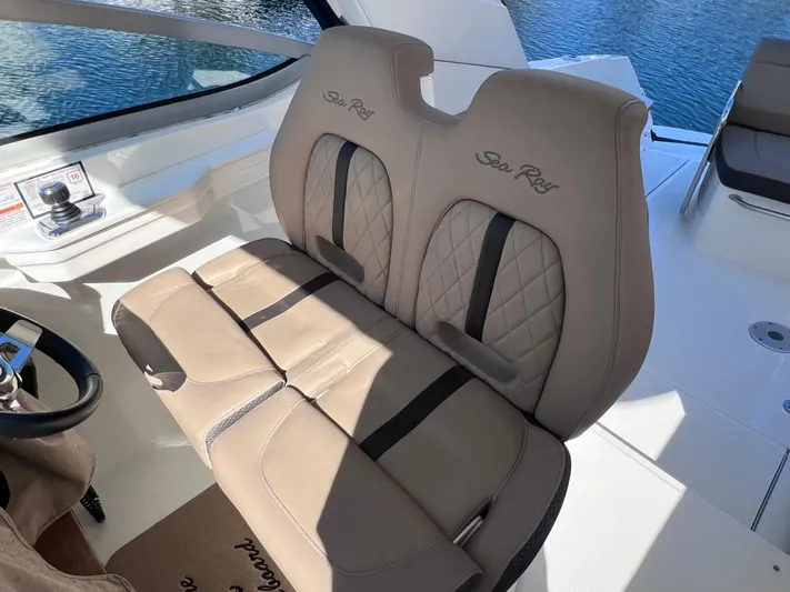  Yacht Photos Pics 2016 Sea Ray 350 Sundancer helm seats with beige upholstery and diamond stitching.