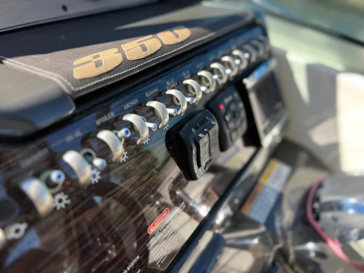  Yacht Photos Pics Close-up of 2016 Sea Ray 350 Sundancer control panel with switches and dials.
