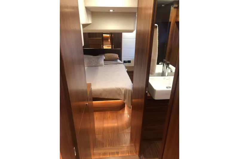  Yacht Photos Pics Luxurious cabin interior of 2020 Sundeck Yachts 580 with elegant wood finishes.
