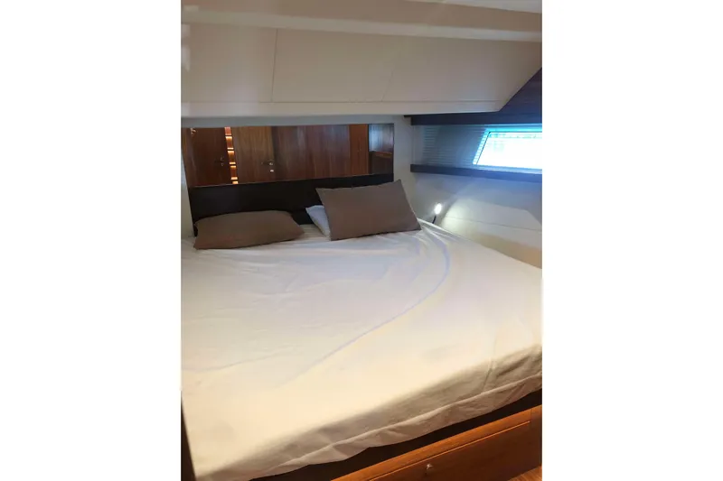  Yacht Photos Pics Luxurious bedroom interior of 2020 Sundeck Yachts 580 with cozy bedding and natural light.