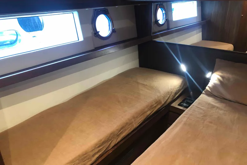  Yacht Photos Pics Interior cabin of 2020 Sundeck Yachts 580 with twin beds and porthole windows.