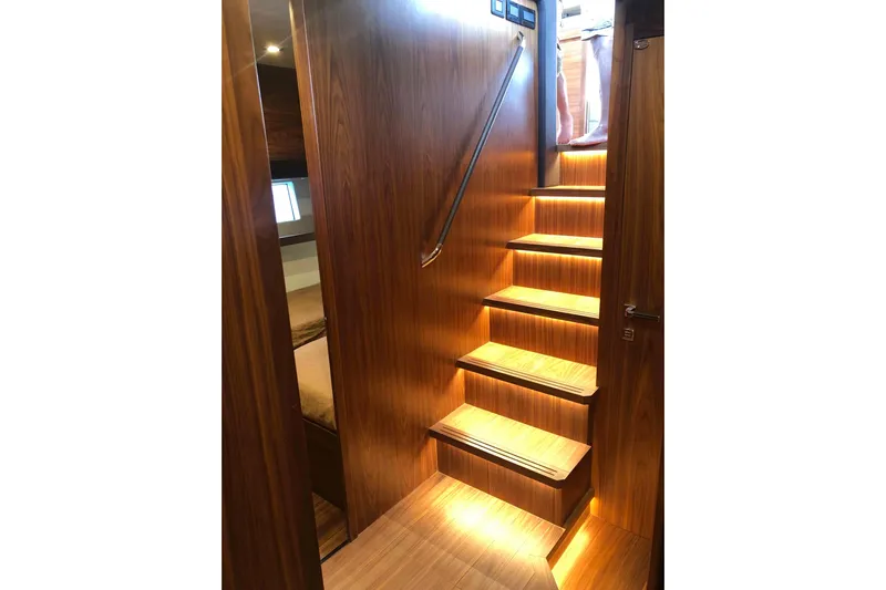  Yacht Photos Pics Luxurious wooden staircase with ambient lighting on Sundeck Yachts 580, 2020 model.
