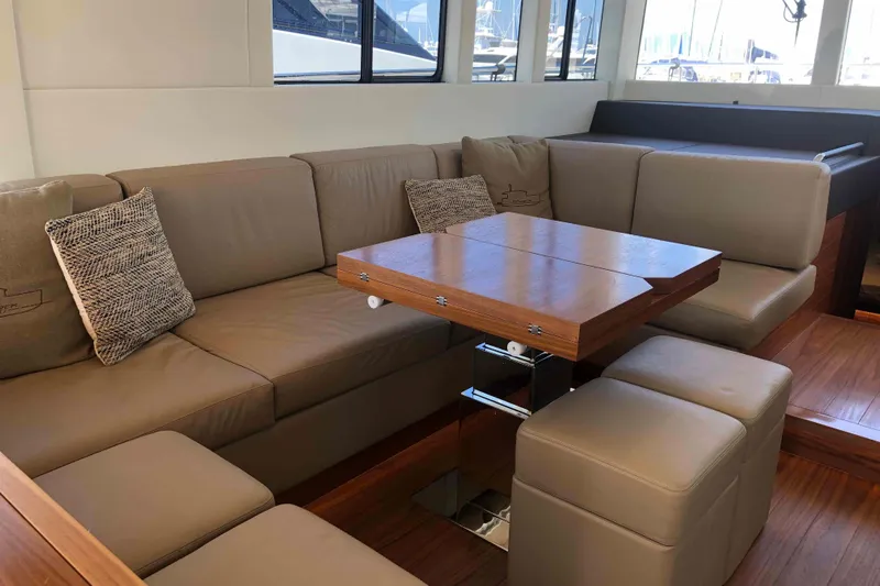  Yacht Photos Pics Luxurious interior of 2020 Sundeck Yachts 580 with elegant seating and wooden table.
