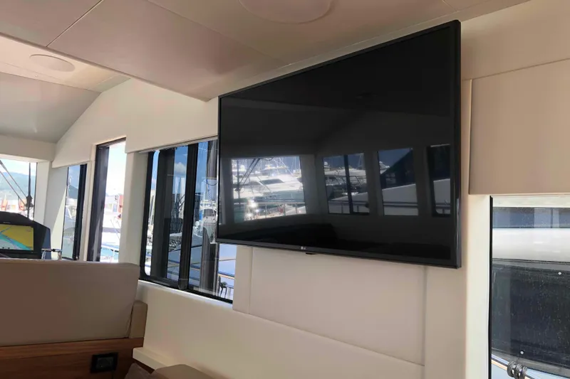  Yacht Photos Pics Interior of 2020 Sundeck Yachts 580 with large TV and panoramic windows.