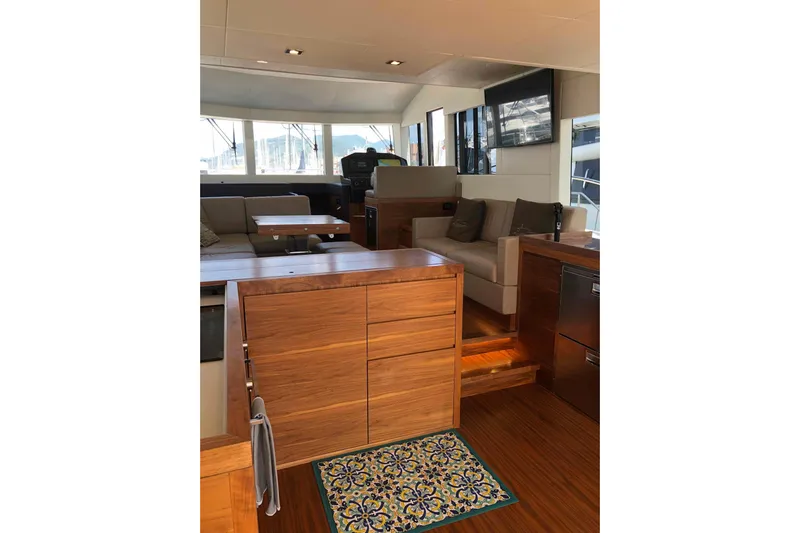  Yacht Photos Pics Luxurious interior of 2020 Sundeck Yachts 580 with modern wood finishes and seating area.
