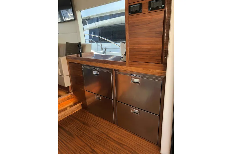  Yacht Photos Pics Luxurious interior of 2020 Sundeck Yachts 580 with sleek wood and stainless steel finishes.