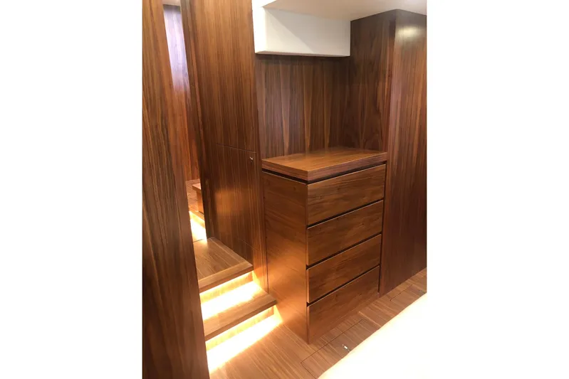  Yacht Photos Pics Luxurious wooden interior of 2020 Sundeck Yachts 580, featuring elegant cabinetry and ambient lighting.