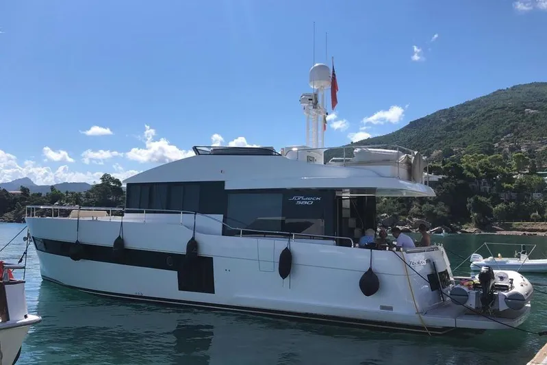  Yacht Photos Pics Luxury 2020 Sundeck Yachts 580 moored in scenic coastal waters.