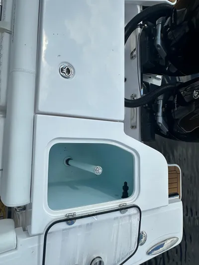  Yacht Photos Pics 2024 Southport 30 FE boat with open storage compartment and visible engine components.