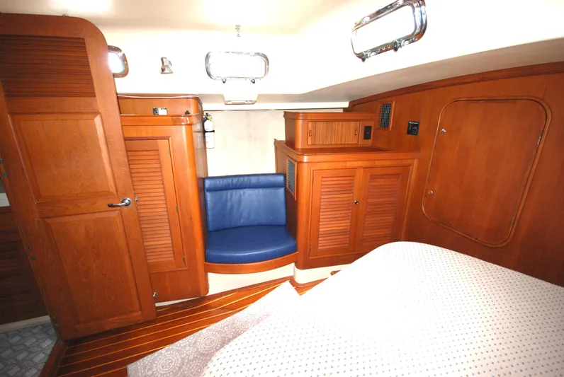 Priva Sea Yacht Photos Pics Interior of 2003 Island Packet 485 yacht with wooden cabinetry and blue seating.